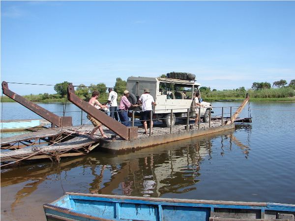 Vehicle crossing a river on a pontoon ferry